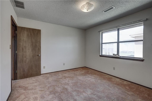 2301 S Stilwell St, Pittsburg, KS 66762 - carpeted empty room featuring visible vents, a textured ceiling, and baseboards