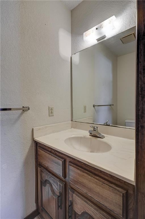 2301 S Stilwell St, Pittsburg, KS 66762 - half bath featuring a textured wall and vanity