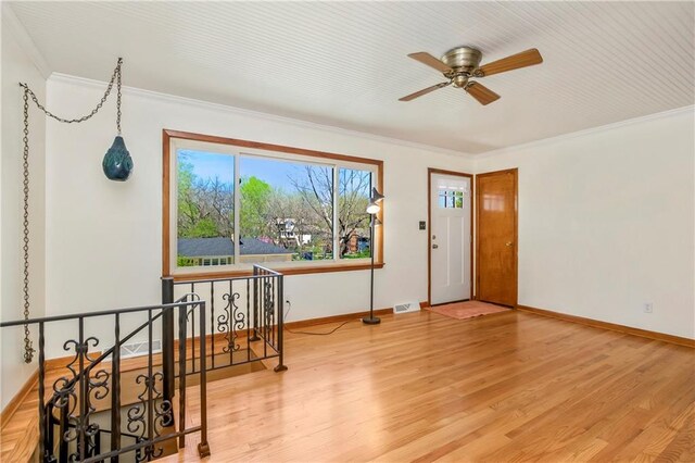 entrance foyer featuring ceiling fan, a wealth of natural light, and wood finished floors