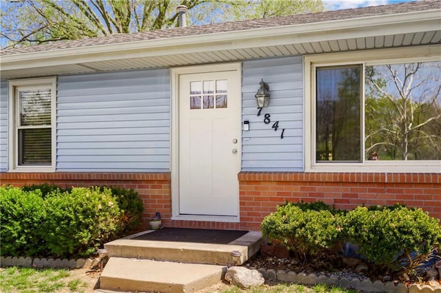 property entrance with brick siding