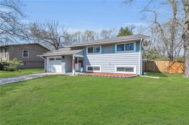 8608 E 91st St, Kansas City, MO 64138 - view of front of house with an attached garage, fence, driveway, and a front lawn