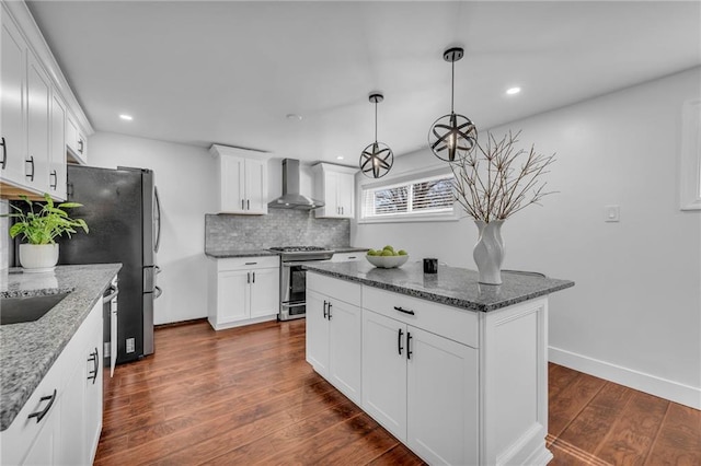 8608 E 91st St, Kansas City, MO 64138 - kitchen with wall chimney range hood, dark wood finished floors, dark stone countertops, and appliances with stainless steel finishes