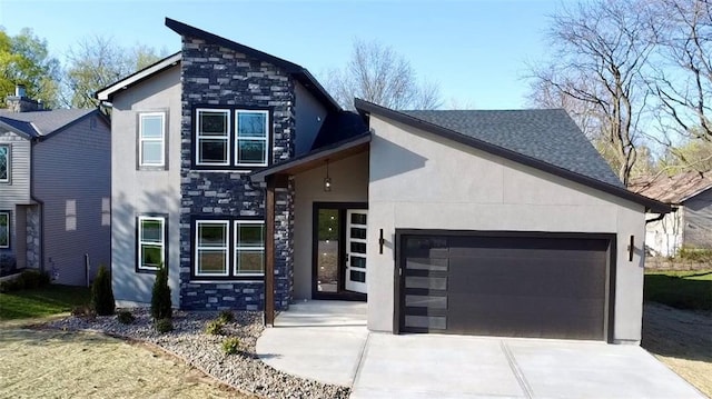 modern home with a garage, stucco siding, and stone siding