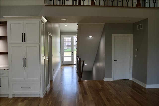 foyer with recessed lighting, visible vents, baseboards, and dark wood-style floors
