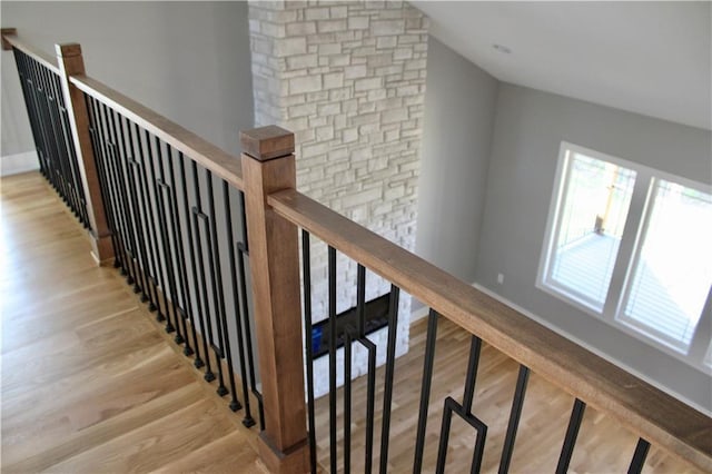 staircase featuring baseboards and wood finished floors