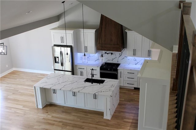 kitchen featuring stainless steel fridge with ice dispenser, custom exhaust hood, white cabinets, gas stove, and light stone counters