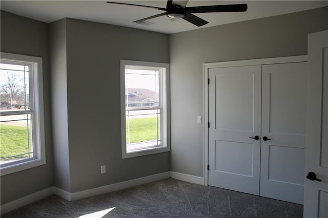 unfurnished bedroom with a closet, ceiling fan, baseboards, and carpet floors