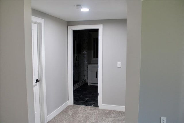corridor with carpet flooring and baseboards