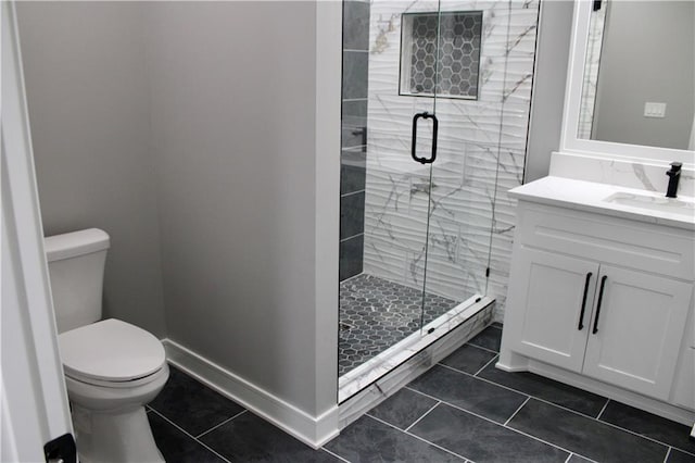 full bathroom featuring toilet, a stall shower, vanity, and tile patterned floors