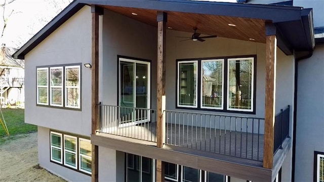 view of home's exterior with ceiling fan and stucco siding