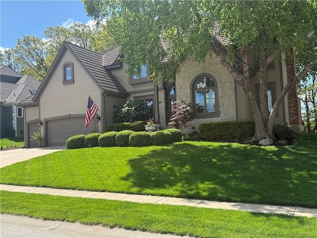 5316 NE Northgate Xing, Lees Summit, MO 64064 - view of front of home featuring stucco siding, stone siding, concrete driveway, a front lawn, and an attached garage
