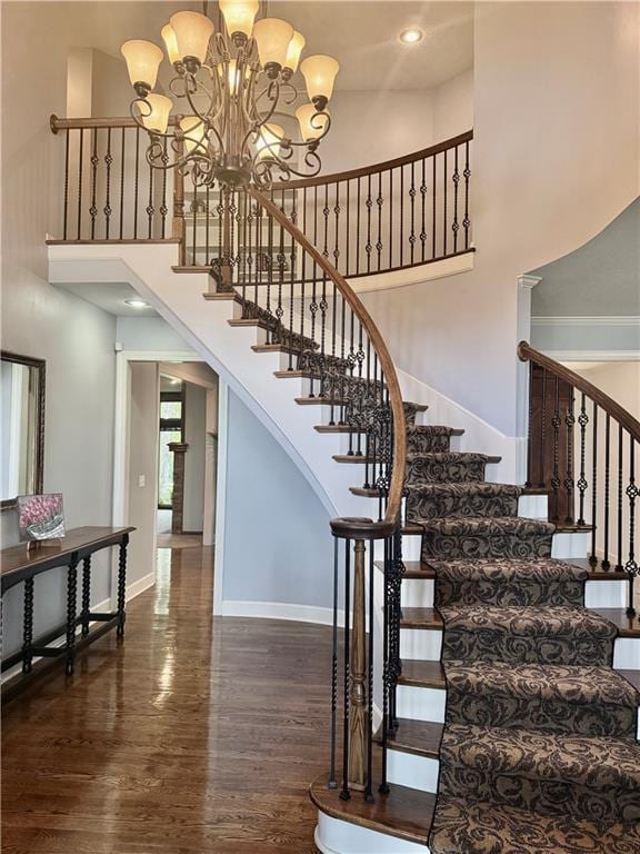 5316 NE Northgate Xing, Lees Summit, MO 64064 - stairs with a towering ceiling, wood finished floors, a chandelier, and baseboards