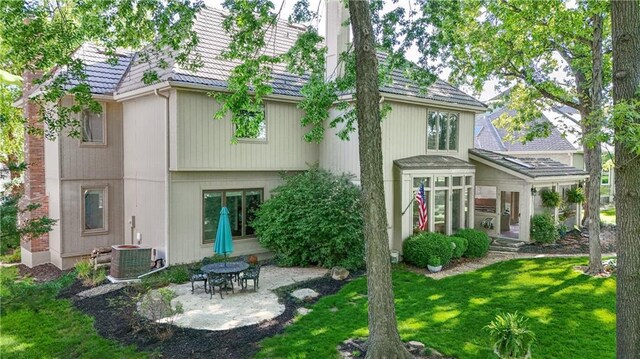 5316 NE Northgate Xing, Lees Summit, MO 64064 - rear view of property with a patio, a tiled roof, central AC unit, and a lawn