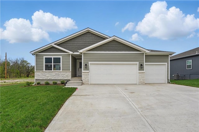 1002 Branchwood Ln, Raymore, MO 64083 - craftsman-style home featuring an attached garage, concrete driveway, stone siding, and a front yard