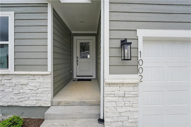1002 Branchwood Ln, Raymore, MO 64083 - property entrance featuring stone siding