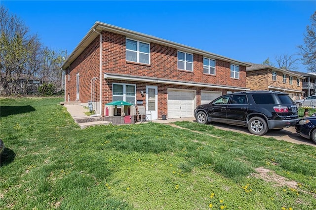 3520 S Lynn St, Independence, MO 64055 - view of front of property featuring brick siding, a front yard, driveway, and a garage