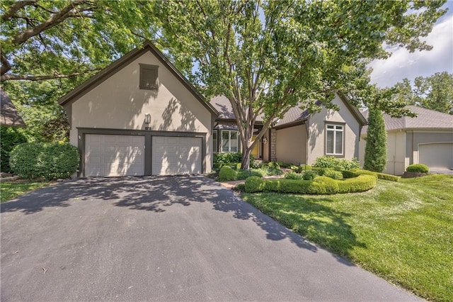 5400 W 97th Cir W, Overland Park, KS 66207 - view of front of home featuring stucco siding, driveway, a front yard, and an attached garage