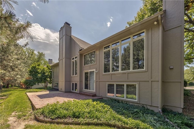 5400 W 97th Cir W, Overland Park, KS 66207 - back of house featuring a chimney and a patio area