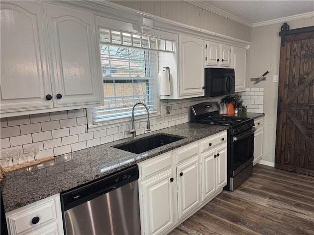 kitchen featuring crown molding, white cabinets, a sink, black appliances, and dark wood finished floors
