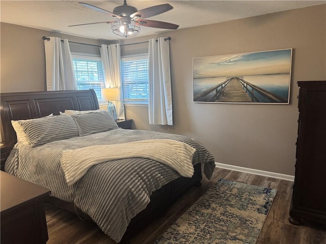 bedroom with wood finished floors, ceiling fan, and baseboards