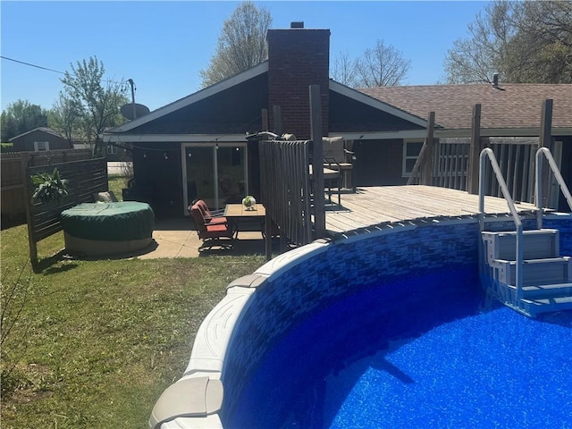 912 Circle Dr, Independence, KS 67301 - view of pool with fence, a deck, and a patio