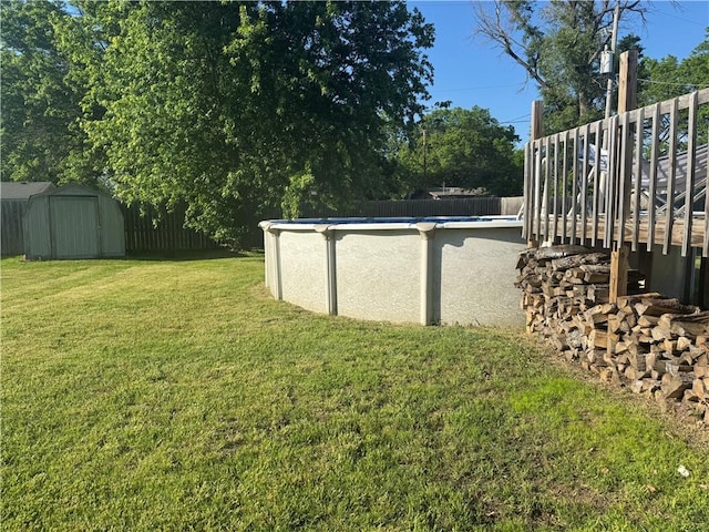 912 Circle Dr, Independence, KS 67301 - view of yard featuring a storage unit, an outdoor structure, and a wooden deck