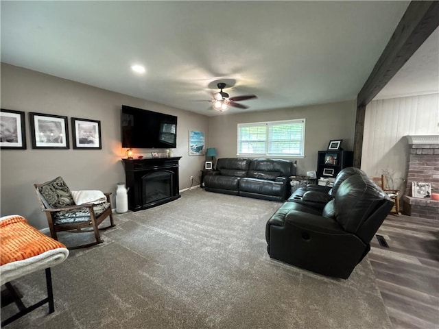 912 Circle Dr, Independence, KS 67301 - living room with a brick fireplace, a ceiling fan, wood finished floors, and beamed ceiling