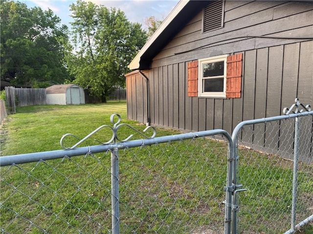 912 Circle Dr, Independence, KS 67301 - view of property exterior with a gate, board and batten siding, a storage shed, and an outbuilding