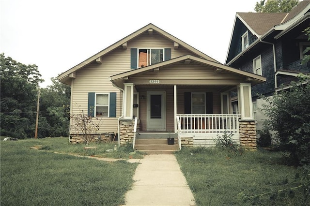 3344 S Benton Ave, Kansas City, MO 64128 - view of front of property with a front lawn and a porch