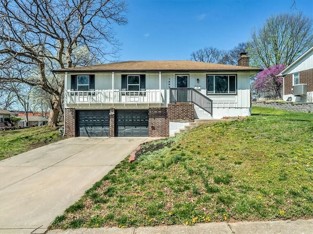 single story home featuring a chimney, driveway, board and batten siding, an attached garage, and a front yard