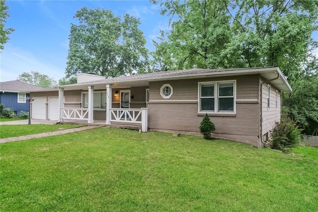 ranch-style house with brick siding, a front lawn, an attached garage, and driveway