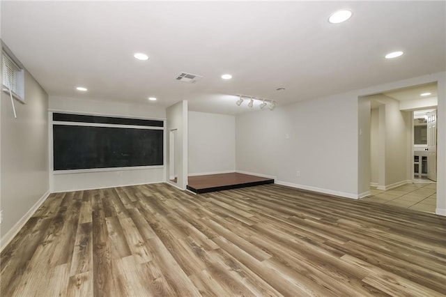 basement with recessed lighting, visible vents, baseboards, and wood finished floors