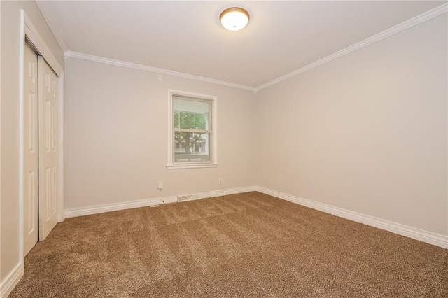 unfurnished bedroom featuring ornamental molding, baseboards, a closet, and carpet