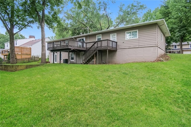 back of house with stairs, a yard, a wooden deck, and fence