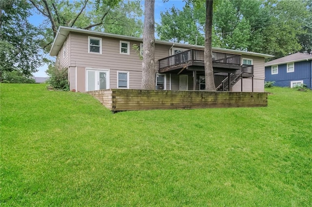 rear view of property with stairway, a yard, and a deck