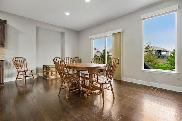 dining room with recessed lighting, baseboards, dark wood-type flooring, and visible vents