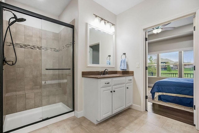 ensuite bathroom with vanity, a ceiling fan, connected bathroom, and a stall shower