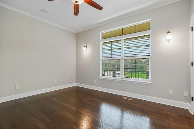 unfurnished room with crown molding, visible vents, wood finished floors, baseboards, and ceiling fan