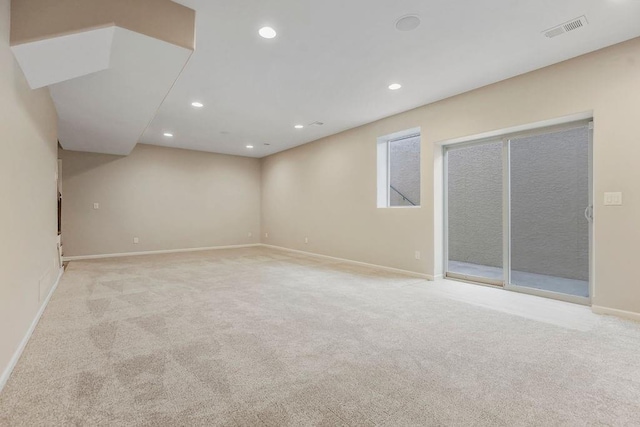 below grade area with carpet floors, baseboards, recessed lighting, and visible vents