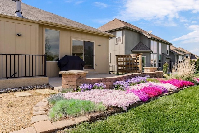 rear view of property featuring fence