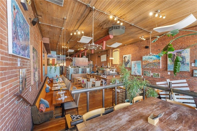 interior space with brick wall and wooden ceiling