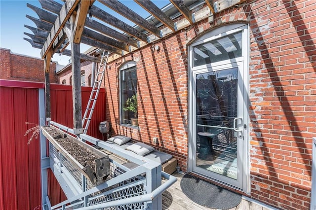 exterior space with brick siding and fence