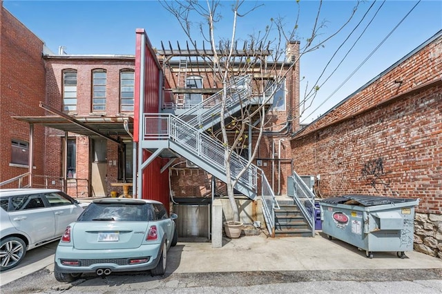 exterior space featuring brick siding and stairway