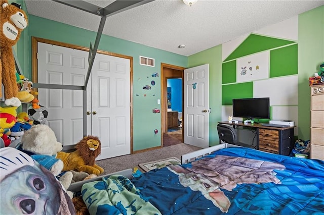 carpeted bedroom featuring visible vents and a textured ceiling
