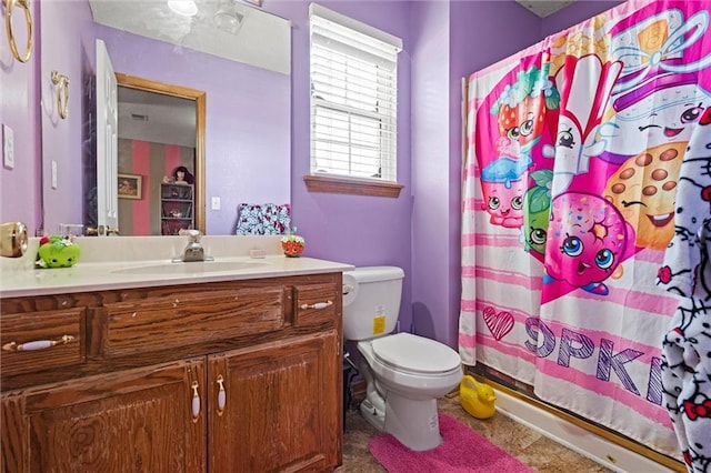 full bath featuring toilet, a shower with shower curtain, and vanity