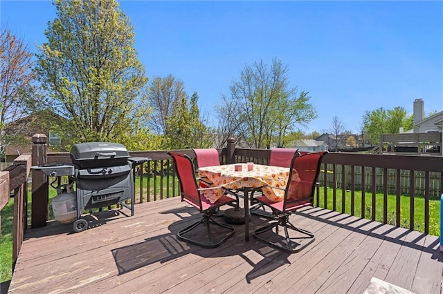 wooden deck featuring outdoor dining area and grilling area