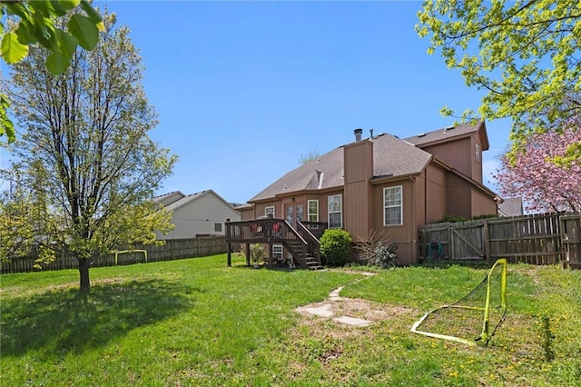view of yard featuring a deck, stairs, and a fenced backyard