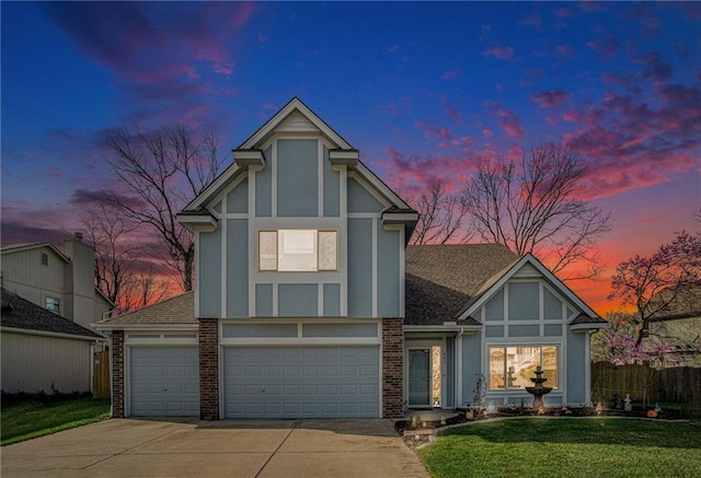401 NW 51st St, Gladstone, MO 64118 - english style home featuring concrete driveway, a front yard, brick siding, a garage, and roof with shingles