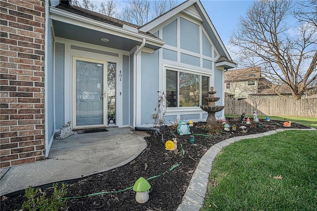 401 NW 51st St, Gladstone, MO 64118 - view of exterior entry featuring stucco siding and brick siding