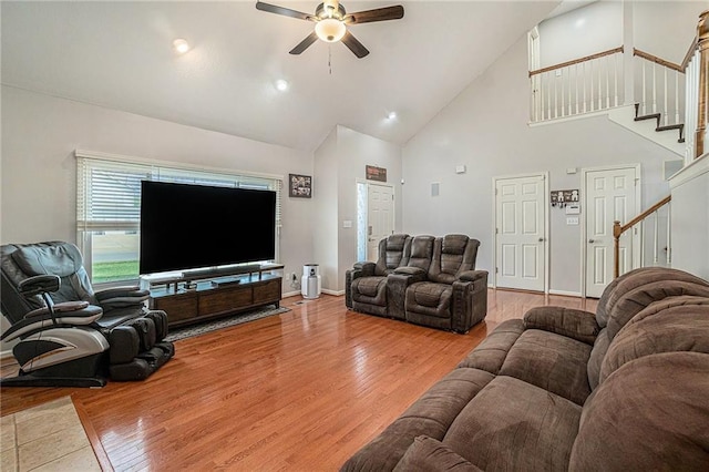 401 NW 51st St, Gladstone, MO 64118 - living room featuring a ceiling fan, stairway, high vaulted ceiling, wood finished floors, and baseboards